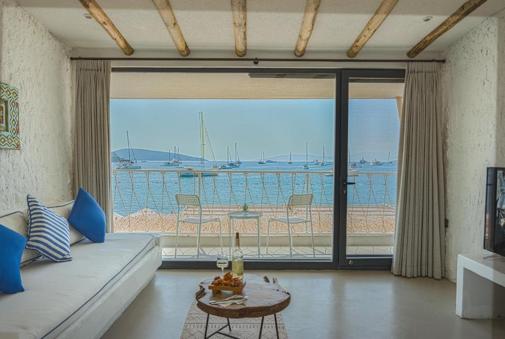 a living room with a couch and a view of the ocean at Churchill Townhouse in Bodrum City