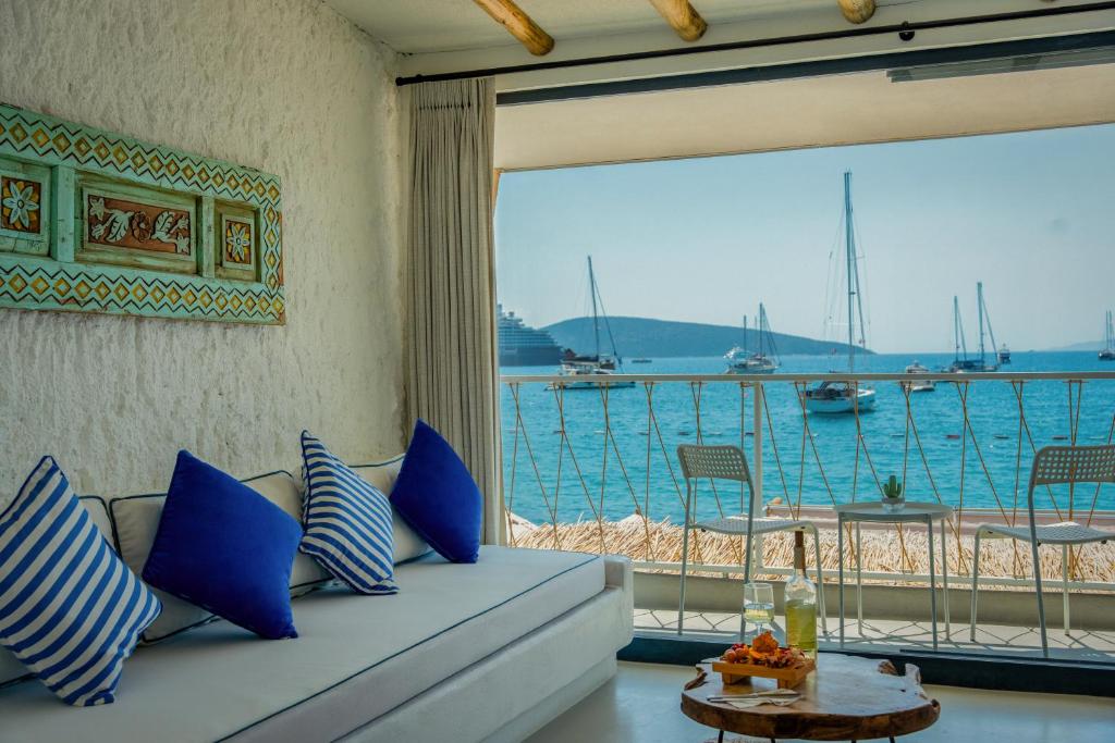 a living room with a couch and a view of the water at Churchill Townhouse in Bodrum City
