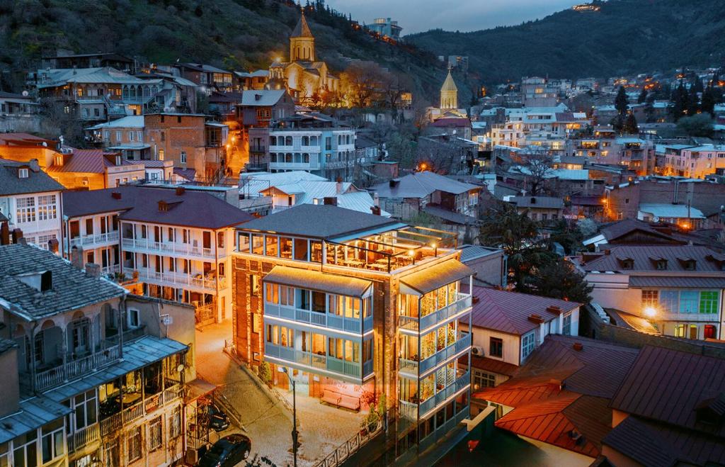 a view of a city at night at TbiliSee Hotel in Tbilisi City