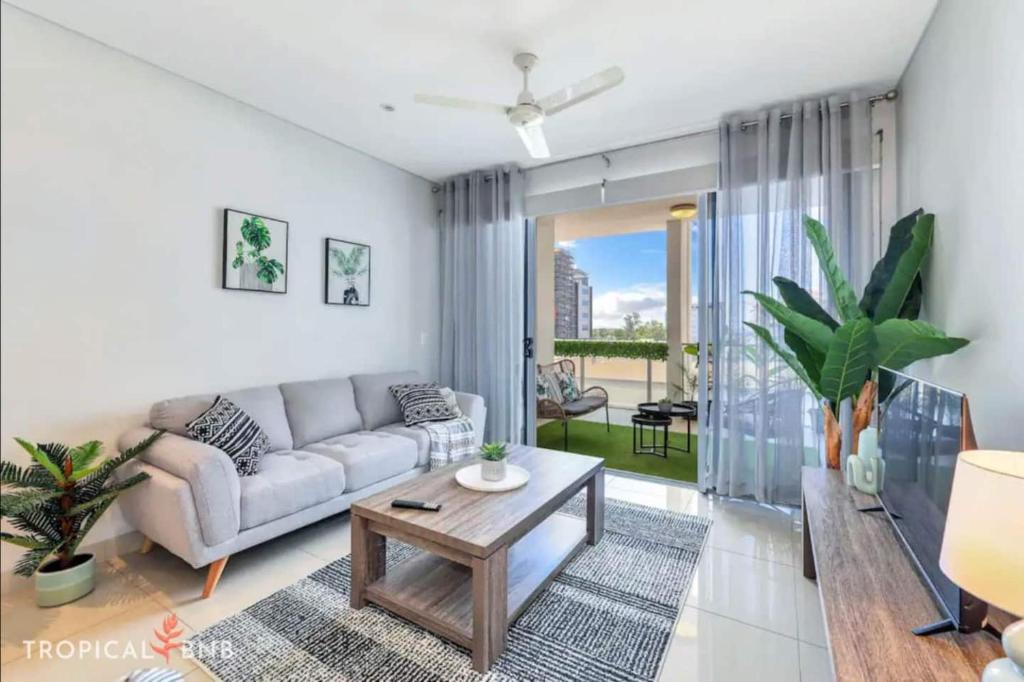 a living room with a couch and a table at Central City 3 Bed Apt, Pool, 2 Free Secured Parks in Darwin