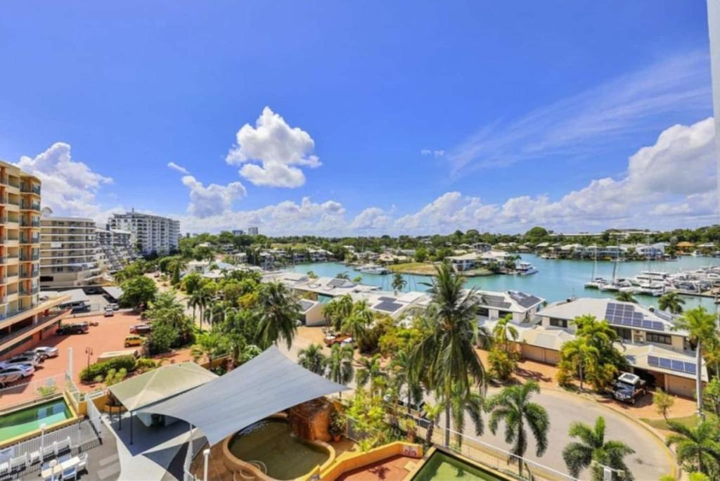 a view of a marina with palm trees and buildings at Marina Magic 2 Bed, 2 Bath Apt Stunning Views in Larrakeyah