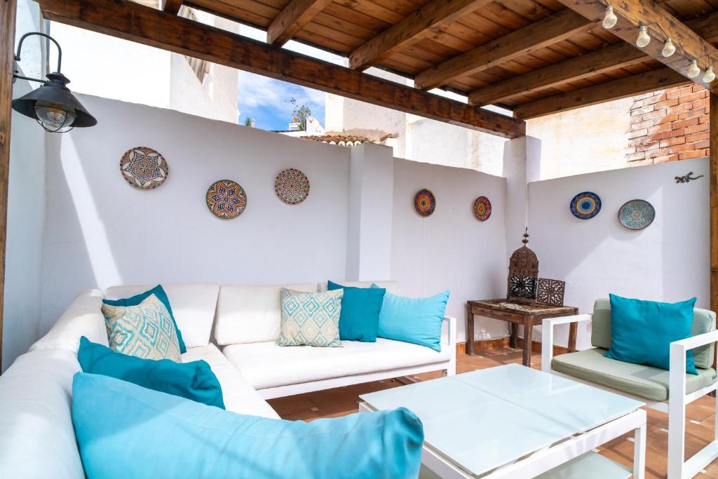 a living room with a white couch and blue pillows at Casa Animas 10 Jacuzzi by Casasol in Nerja