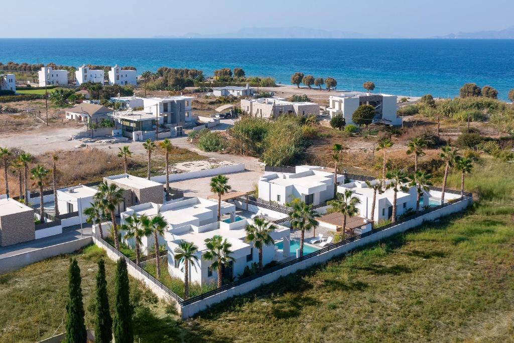 an aerial view of a resort near the ocean at Salty Sun Luxury Villas in Kremasti