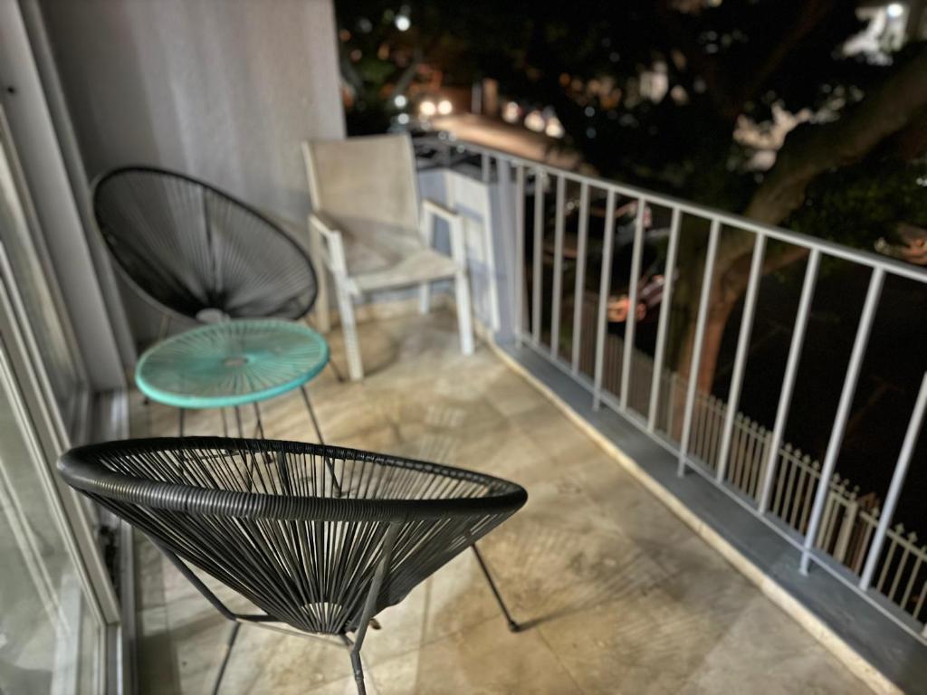 a balcony with a table and a chair on it at Stadium Apartment in Cape Town