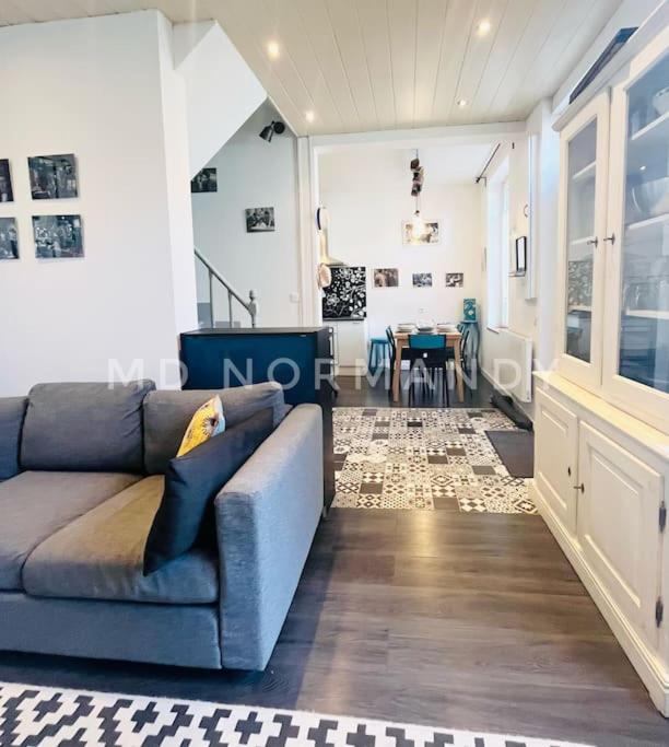 a living room with a blue couch and a table at Belle Maison centre Villerville - 8 personnes - Terrasse in Villerville