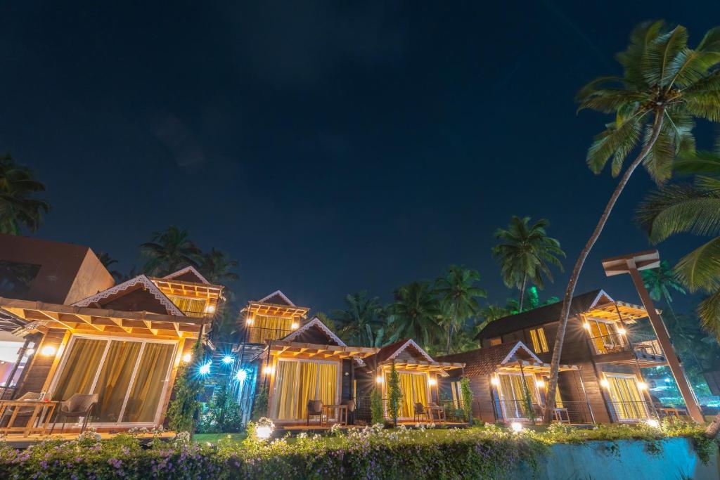 a resort at night with palm trees and lights at Marron Sea View Resort in Patnem