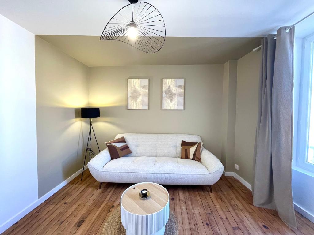un salon avec un canapé et une table dans l'établissement Le Numero 1, à Saint-Jean-dʼAngély