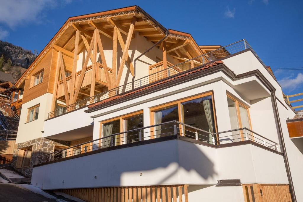 a house under construction with a balcony at Chalet Marcora in Campitello di Fassa