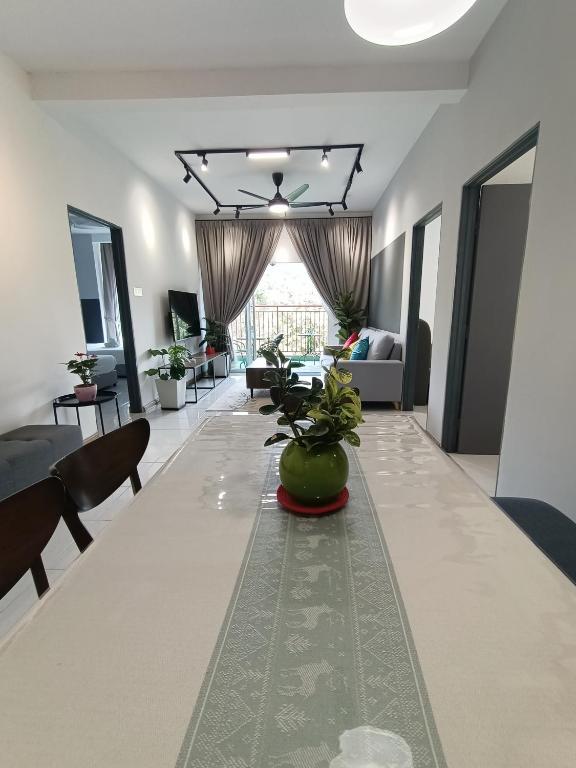 a living room with a long table with chairs and a couch at Dream 6 Emerald avenue in Cameron Highlands