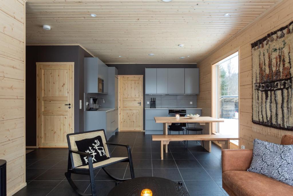 a living room with a couch and a table at Kajo Sky Lodge in Rovaniemi