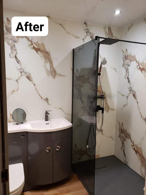a bathroom with a shower and a sink at Sea Air B&B in Chapel Saint Leonards