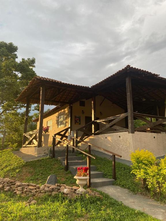 a building with a porch with a roof at Casa da Baleia in Espirito Santo Do Pinhal