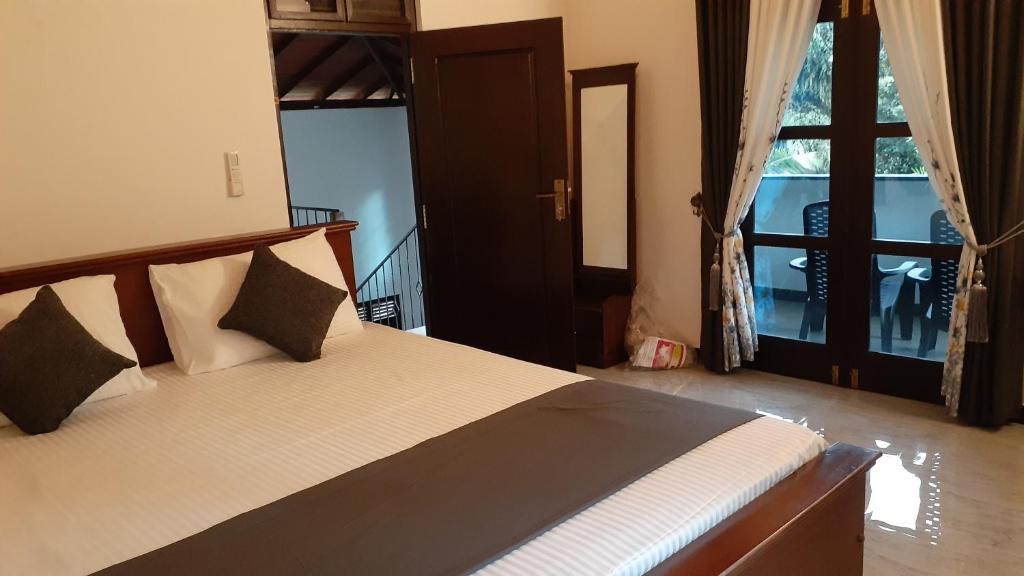 Postel nebo postele na pokoji v ubytování Jithu homestay Mirissa