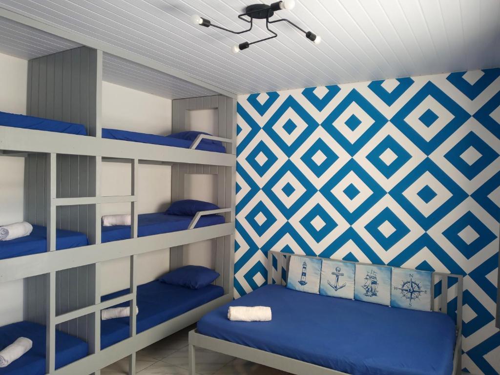 a bunk room with blue bunk beds and a blue and white wall at Guará Apart 4 in Guaratuba
