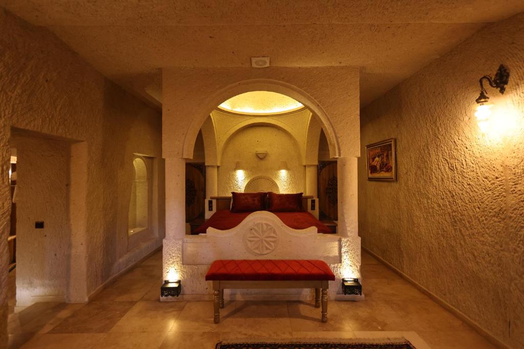 A bed or beds in a room at Cappadocia Inn Cave Hotel