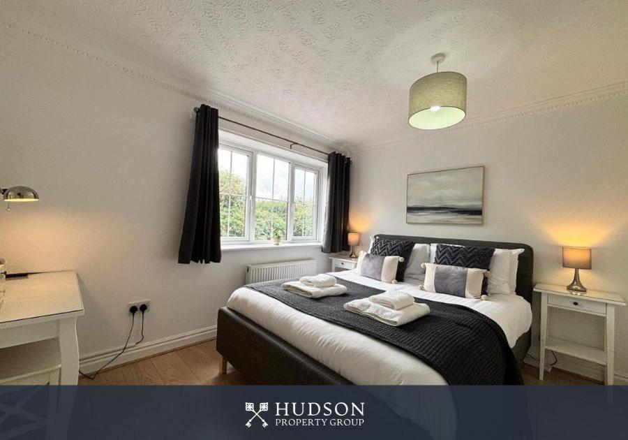 a bedroom with a bed with two towels on it at 3 Bedroom House with Garden in Admaston