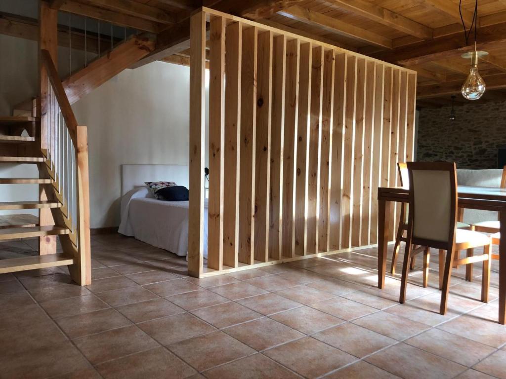 a room with a bed and a table and a staircase at VUT Rural 2 in Arzúa