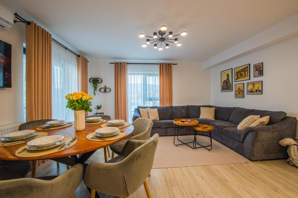 a living room with a table and a couch at Alvera Apartament in Alba Iulia