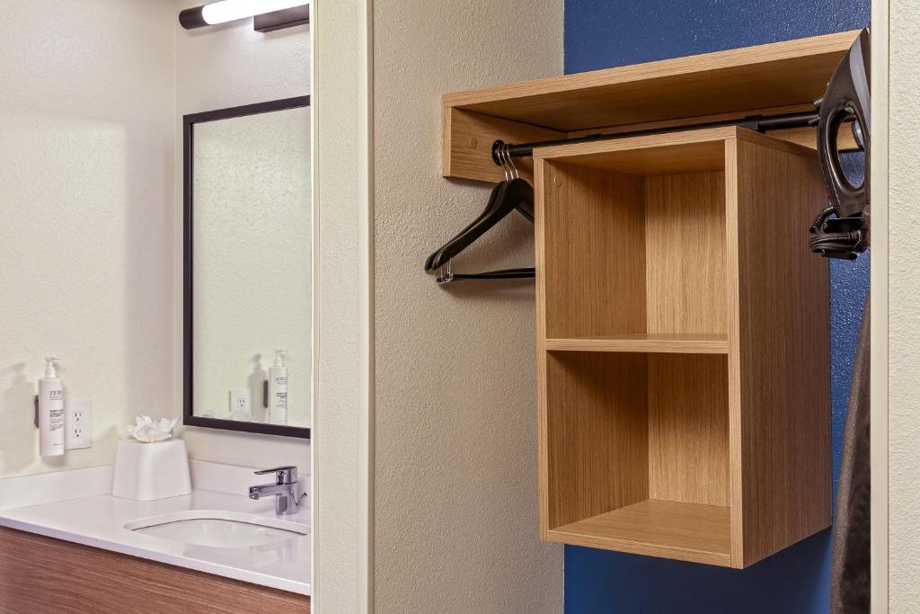 a bathroom with a sink and a mirror at Spark by Hilton Denver International Airport in Denver