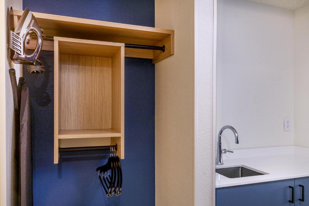 a kitchen with a cupboard and a sink at Spark by Hilton Denver International Airport in Denver