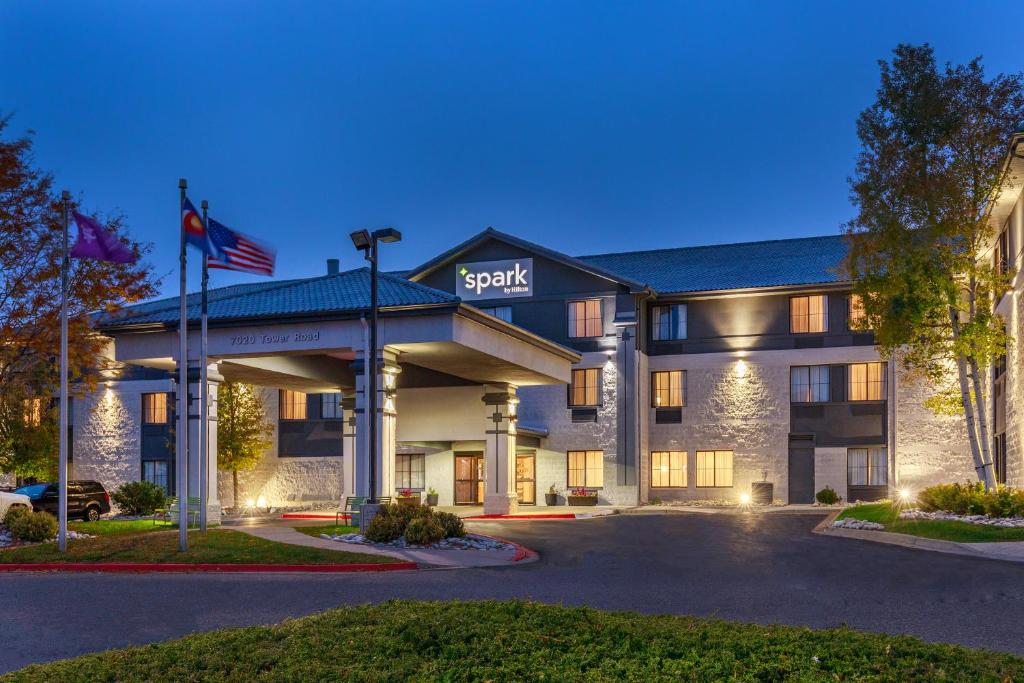 a hotel with an american flag in front of it at Spark by Hilton Denver International Airport in Denver