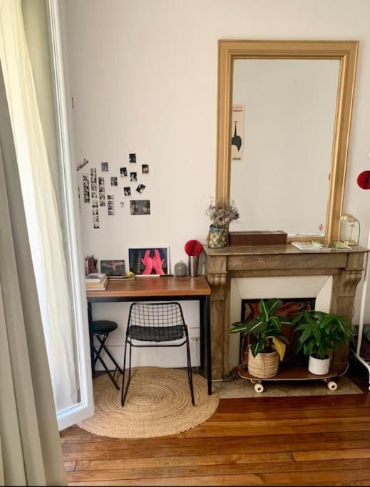 a room with a table and a mirror and a desk at Full house Canal Saint-Martin in Paris