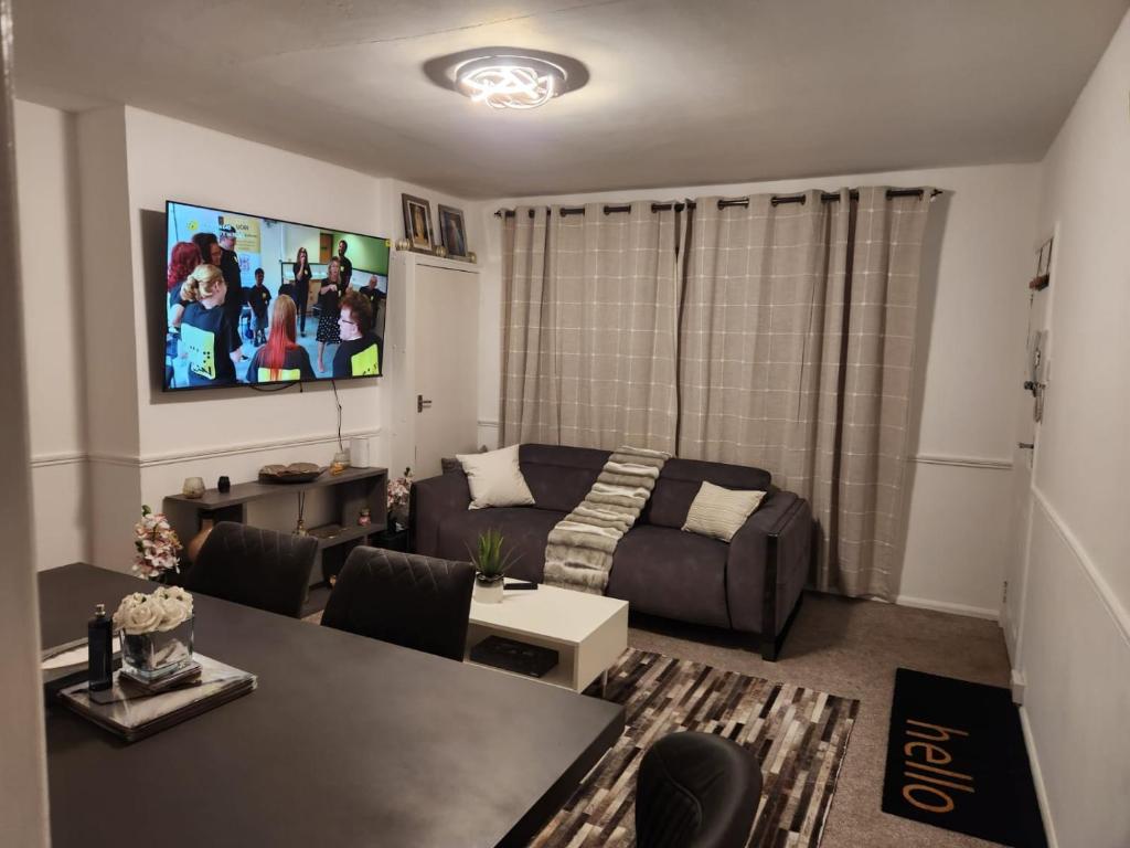 a living room with a couch and a table at Dmltd in Northampton