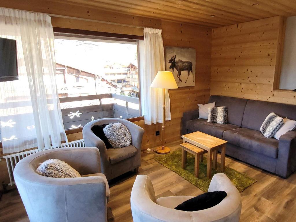 ein Wohnzimmer mit Sofa, Stühlen und einem Tisch in der Unterkunft Appartement rénové, proche pistes, balcon, 3 chambres, parking, Wifi inclus - FR-1-598-132 in Les Gets
