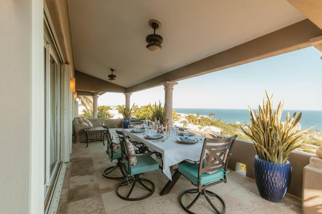 a dining room with a table and chairs and the ocean at Casa de las Olas - Villa Ocean View in San José del Cabo