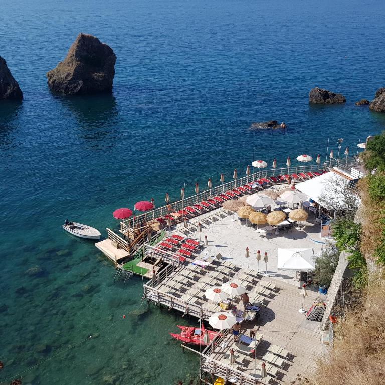 an aerial view of a dock with umbrellas and chairs at B&B DieMme Amalfi Coast in Vietri sul Mare