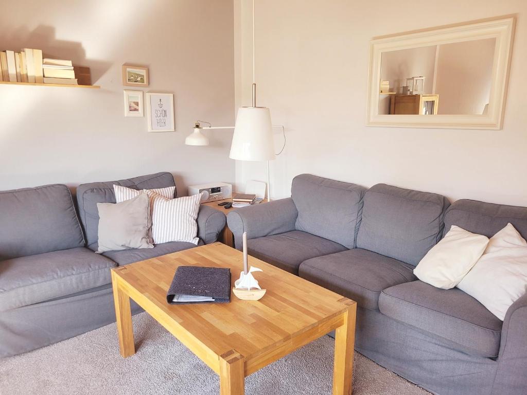 a living room with a couch and a coffee table at Baltrumweg 4 in Wangerland