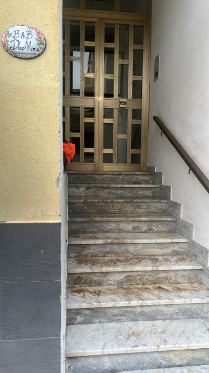 a set of stairs leading to a glass door at B&B DieMme Amalfi Coast in Vietri sul Mare