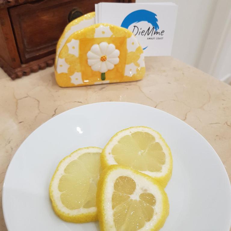 a white plate with lemon slices on a counter at B&B DieMme Amalfi Coast in Vietri sul Mare