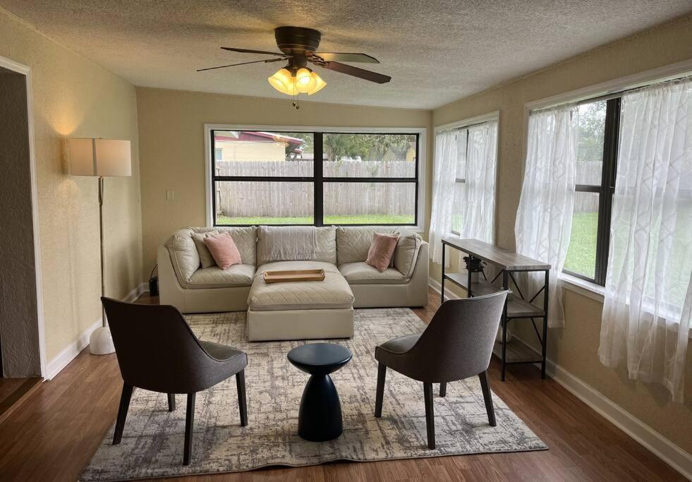 a living room with a couch and chairs at Maison Pierre in Jacksonville