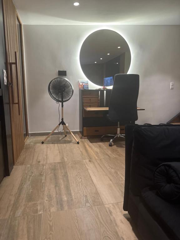 a living room with a desk and a mirror at Ronza in Abidjan