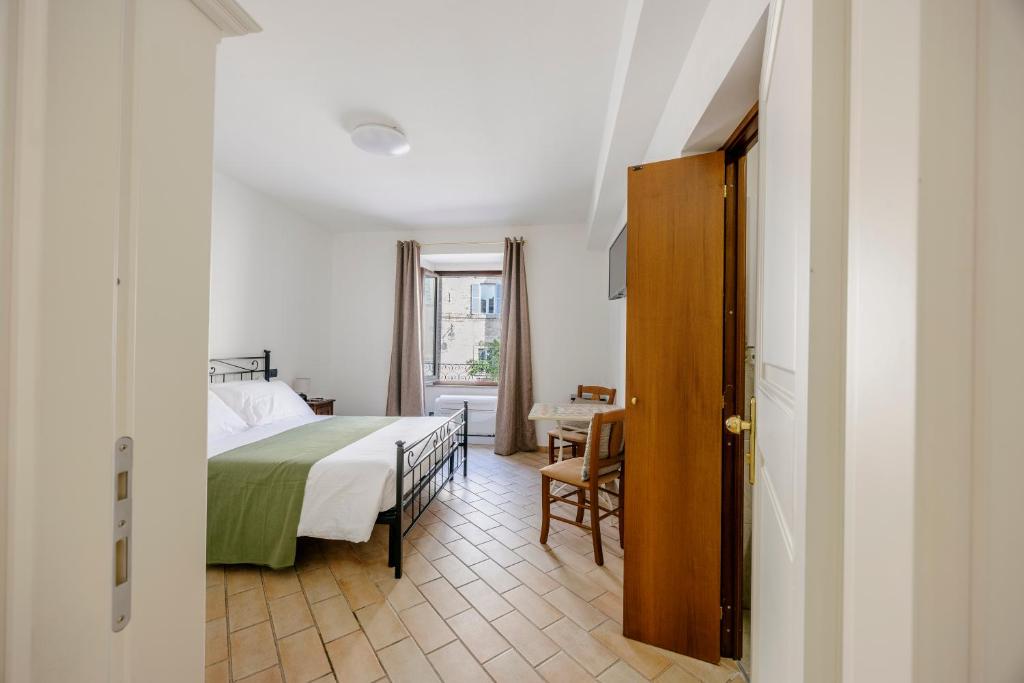 Postel nebo postele na pokoji v ubytování La Cattedrale Rooms