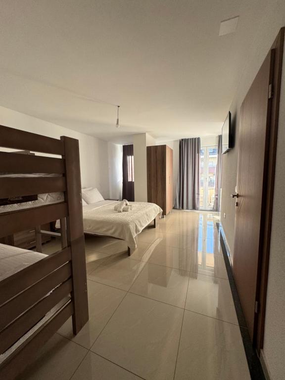 a hotel room with two beds and a hallway at Hotel Palace Struga in Struga