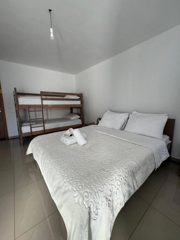 a white bed with two towels on top of it at Hotel Palace Struga in Struga