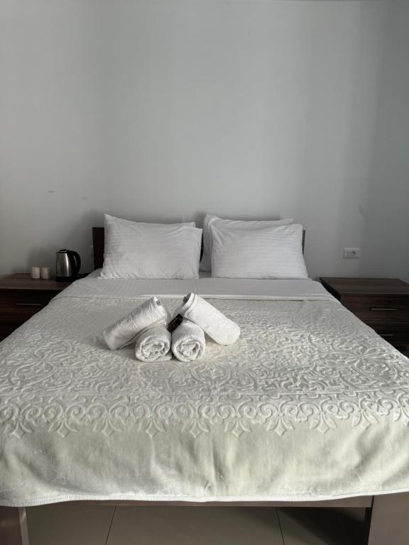 a bed with two towels on top of it at Hotel Palace Struga in Struga