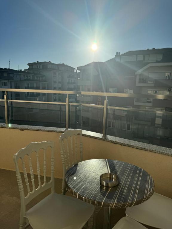 a table and chairs on a balcony with a view at Hotel Palace Struga in Struga