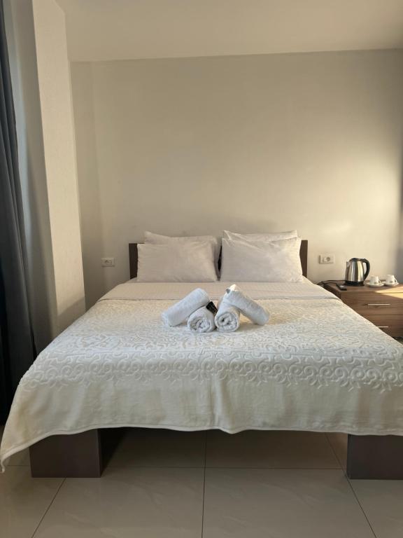 a bed with two rolled up towels on it at Hotel Palace Struga in Struga