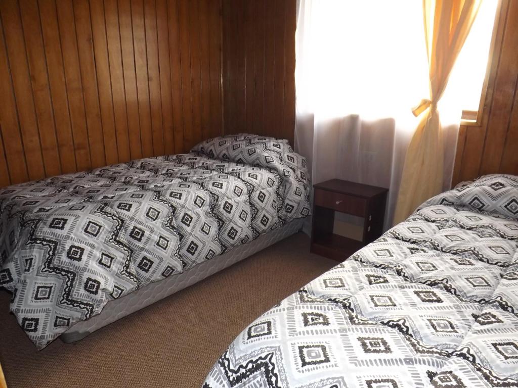 Postel nebo postele na pokoji v ubytování Hotel y Cabañas Pulegan