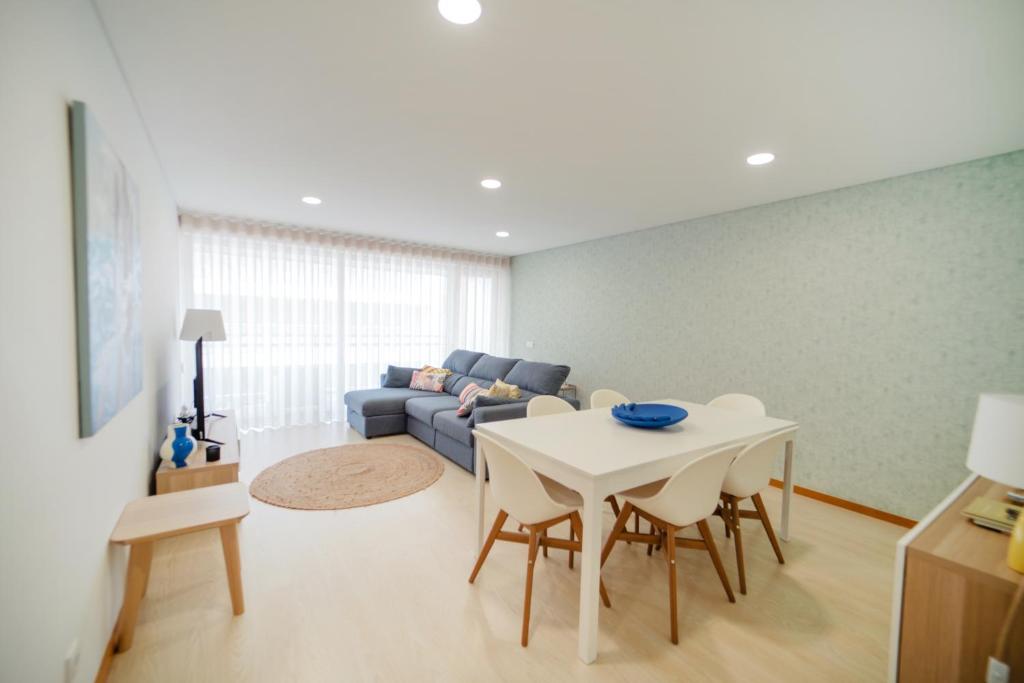 a living room with a table and a couch at Apartamento Lux 1882 in Figueira da Foz