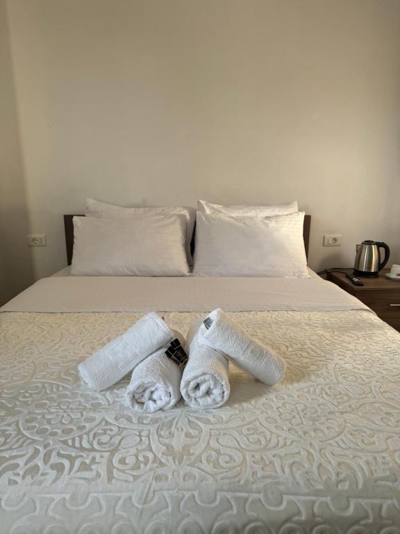two towels sitting on top of a bed at Hotel Palace Struga in Struga