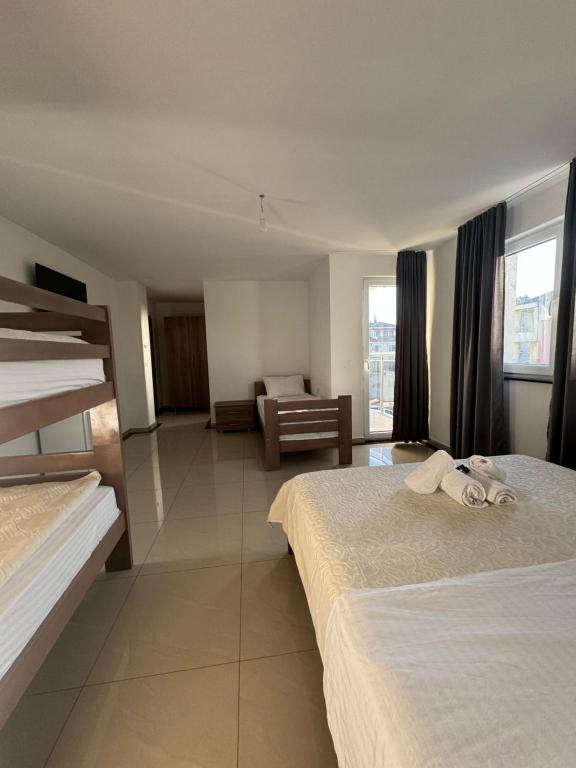 a hotel room with two beds and a couch at Hotel Palace Struga in Struga