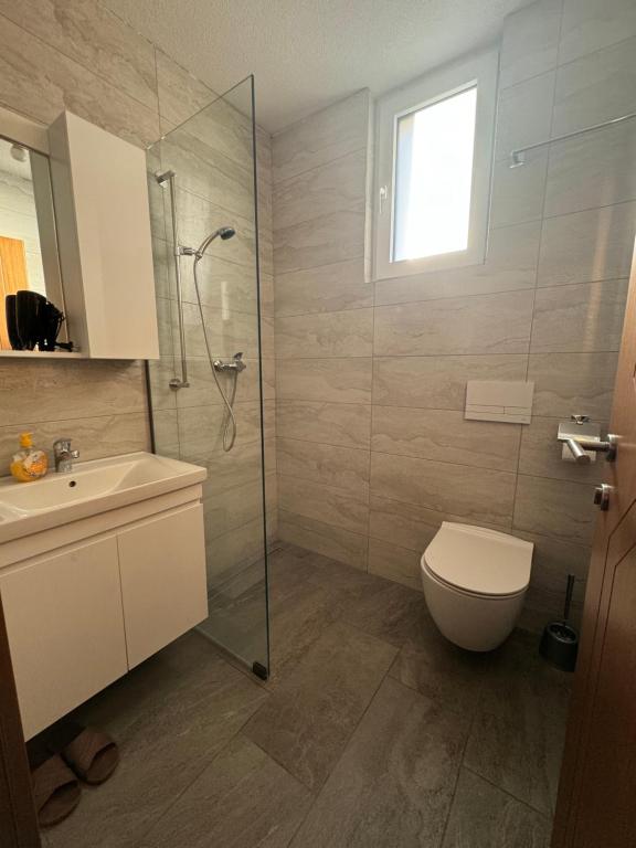 a bathroom with a shower and a toilet and a sink at Hotel Palace Struga in Struga