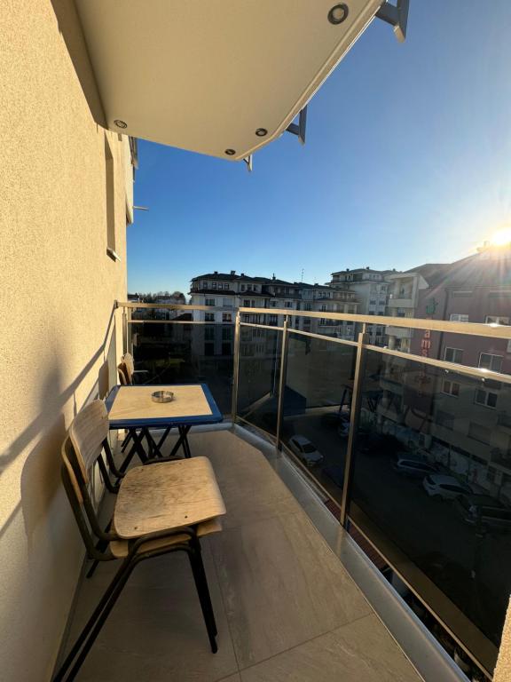 a balcony with a table and chairs on top of a building at Hotel Palace Struga in Struga
