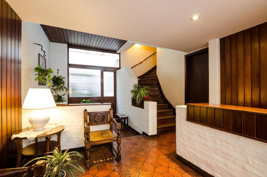 a living room with a table and a chair at Hotel Urca in Mar del Plata