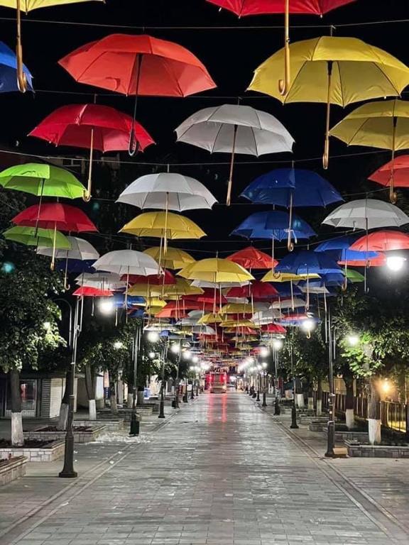 a bunch of colorful umbrellas hanging from a ceiling at Hotel Palace Struga in Struga
