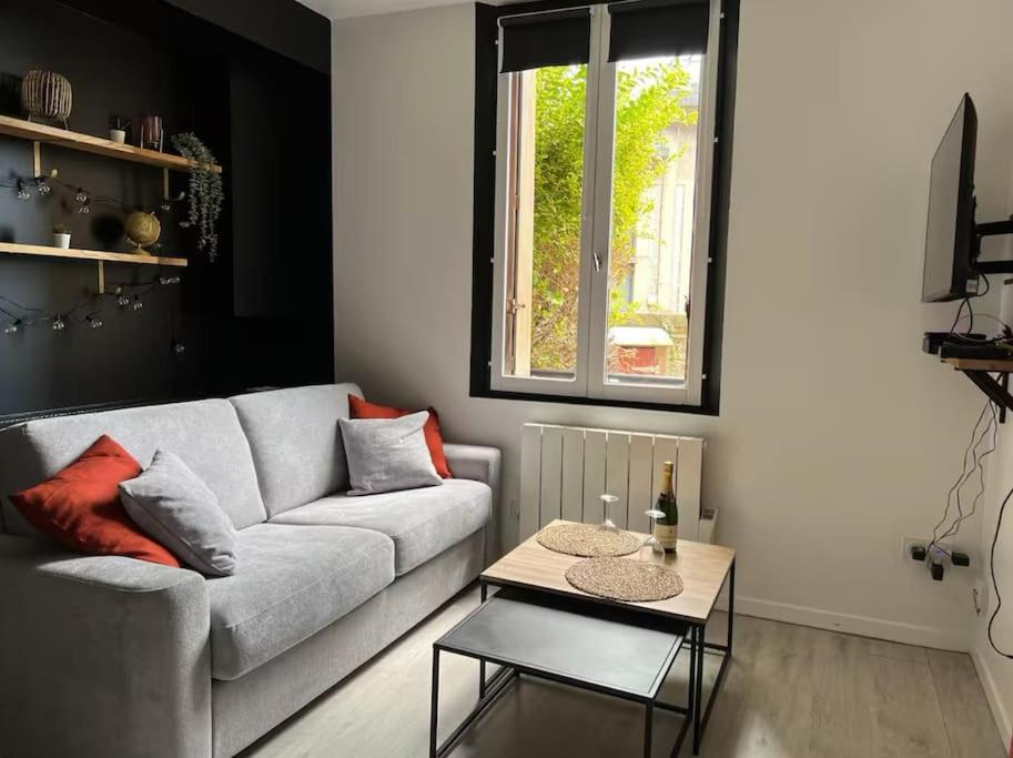 un salon avec un canapé et une table dans l'établissement Appartement Le Petit Galet, au Havre